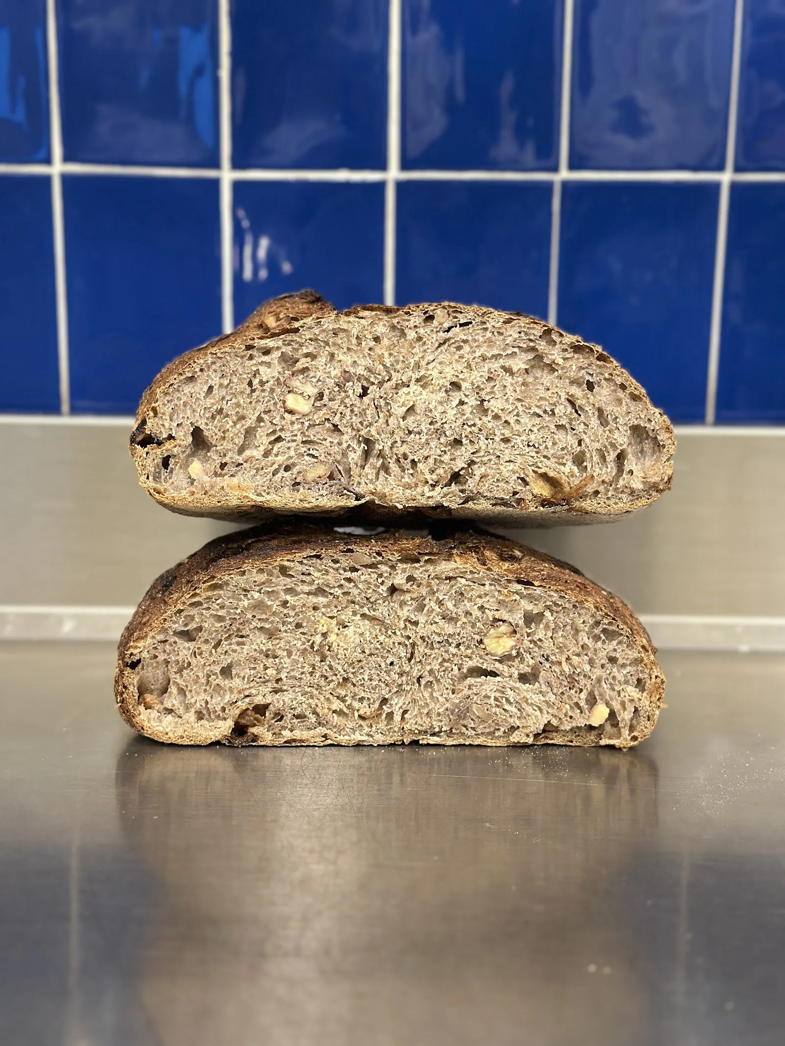 Pan de masa madre cortado por la mitad sobre la mesa del obrador